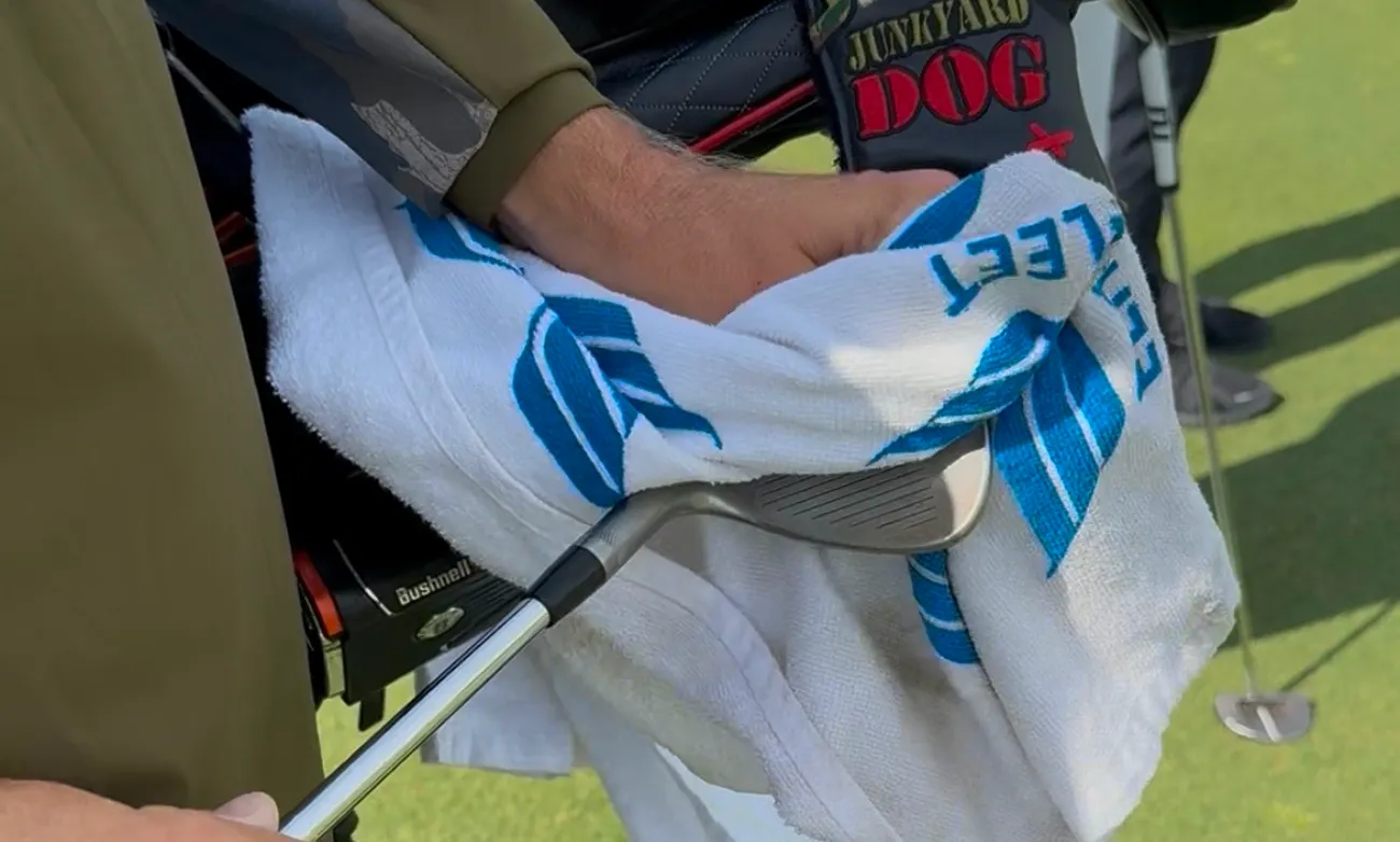 An Elite Fleet caddie preparing a club during a tournament round